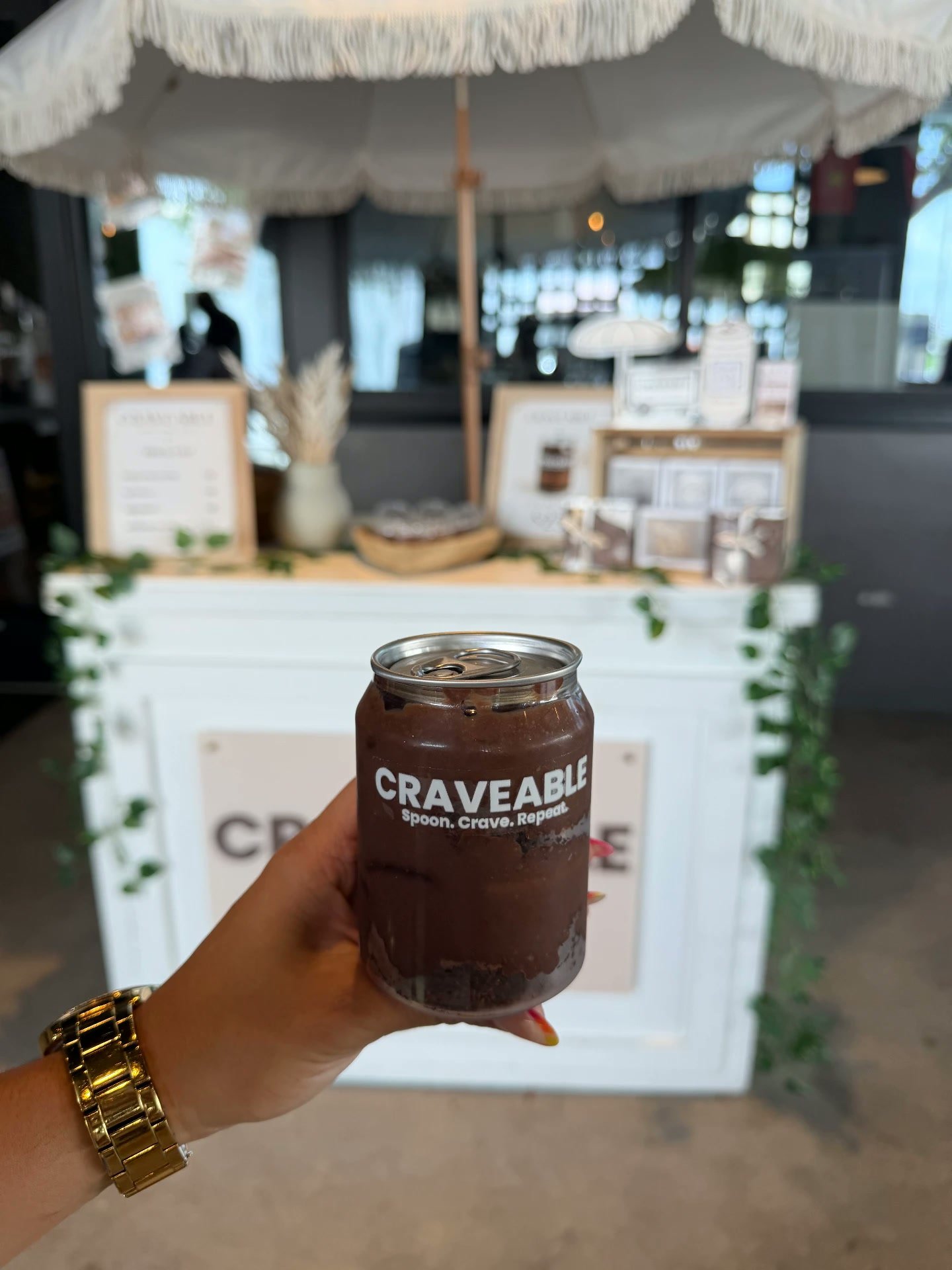 Hands opening a CRAVEABLE can